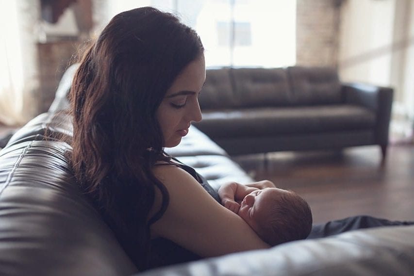 mother holding child by window light Boardman ohio newborn photographer
