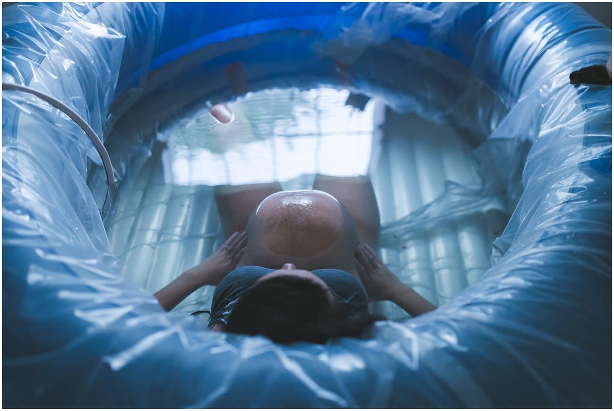 pregnant woman in blue birthing pool for homebirth at Boardman Ohio home Mary Beth Miller Photography