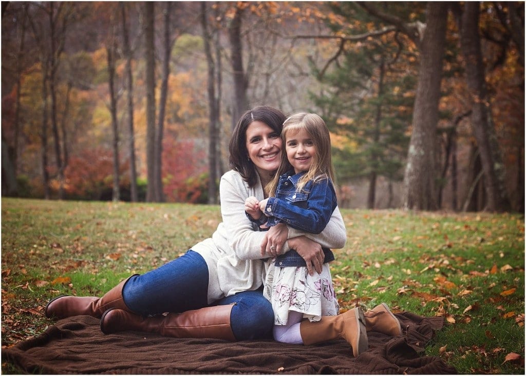 mother with daughter on a blanket at Townsend park in murrysville with fall leaves and foliage in the background