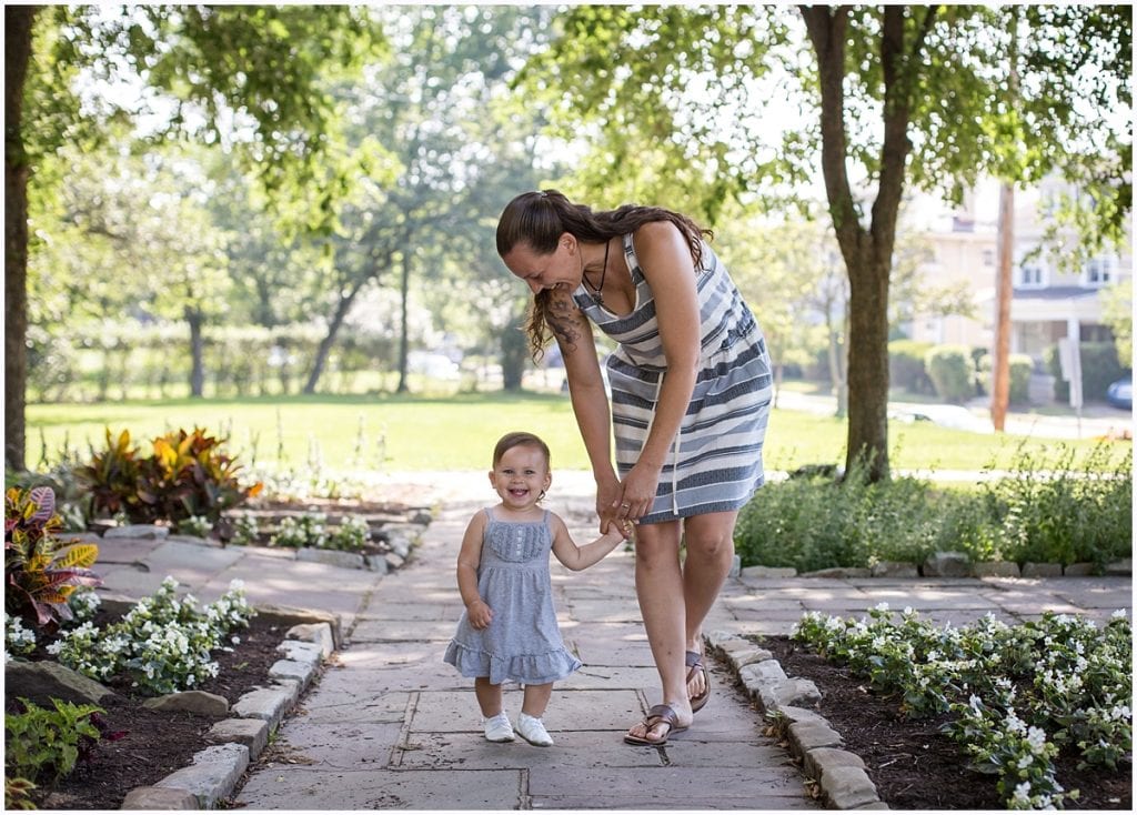 little girl holding hands with mom outside Pittsburgh toddler photographer