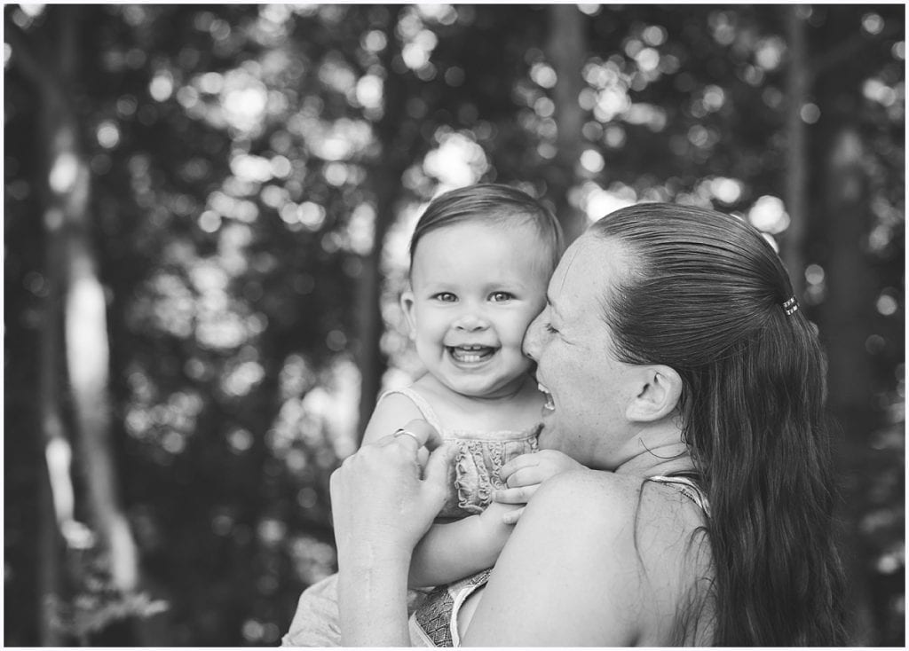 toddler girl smiling at camera with mom outside Pittsburgh toddler photographer