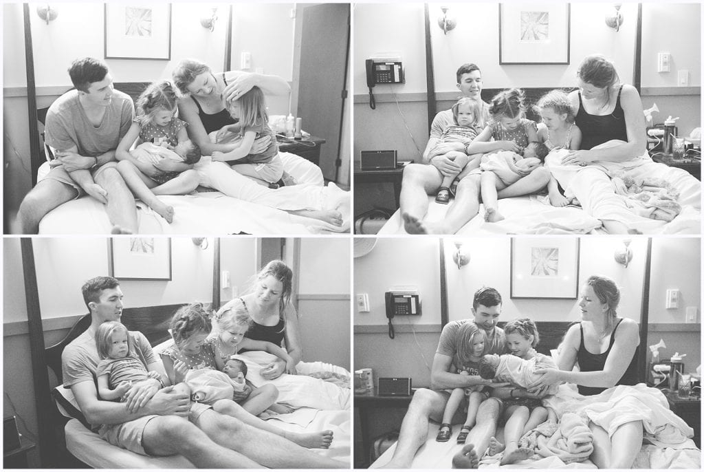 Family with three daughters sitting on bed at Midwife center in Pittsburgh meeting their brand new born baby sister