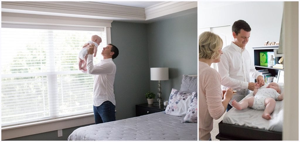 mom and dad with baby by window light and on changing table in nursery