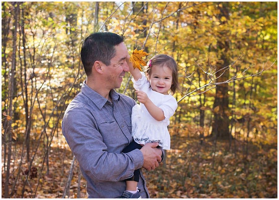 father and daughter in woods with fall foliage in pittsburgh 