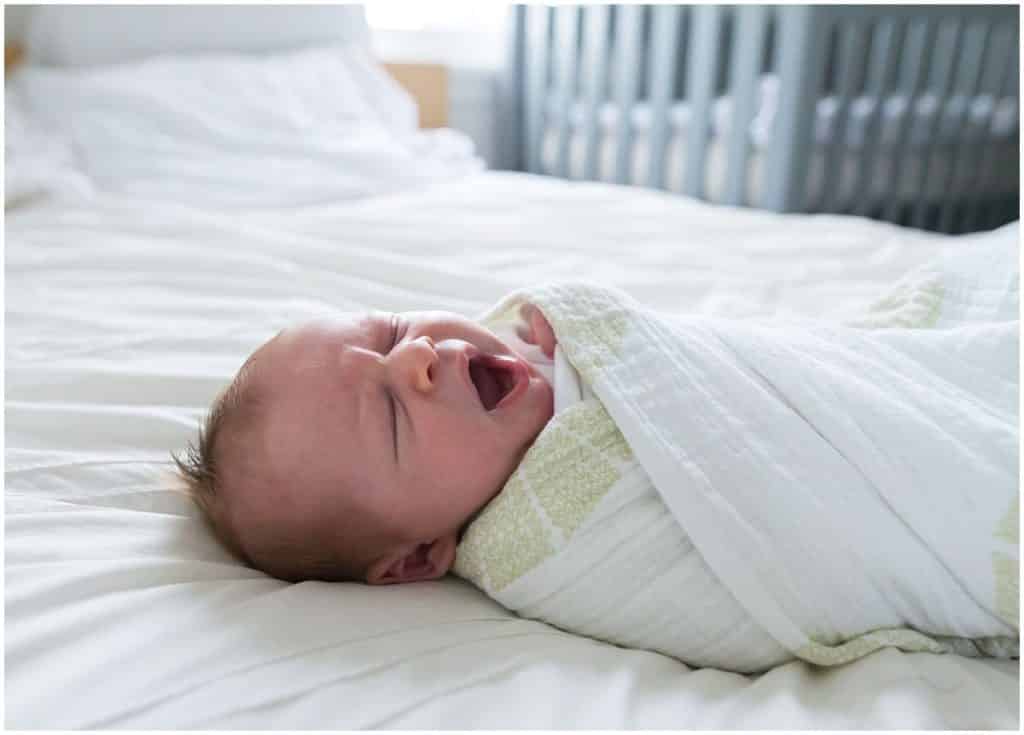 squirrel hill pittsburgh newborn session yawning newborn on bed