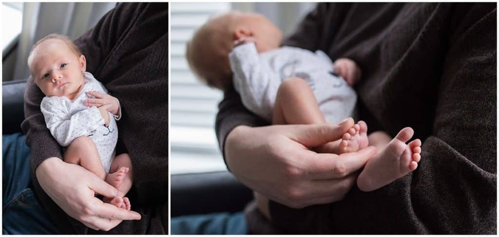 newborn baby feet in dads hands in nursery 