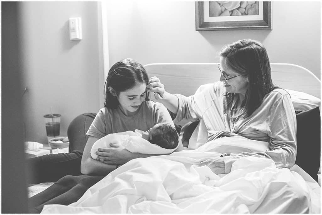 the Midwife Center Pittsburgh Mother and daughters sisters newborn on bed