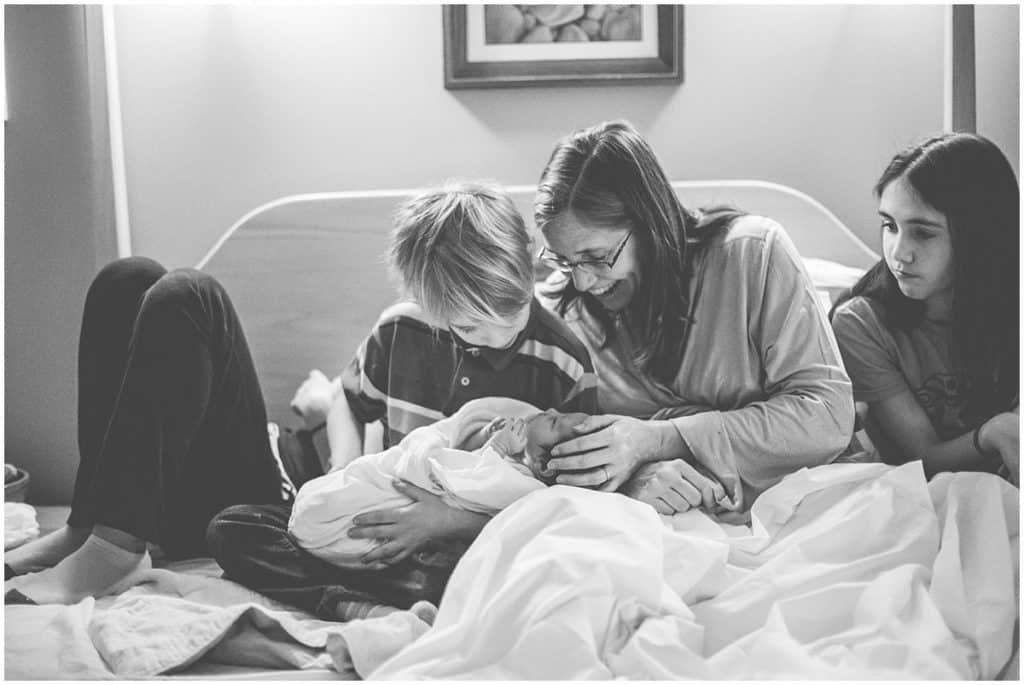 the Midwife Center Pittsburgh Mother son sibling newborn on bed