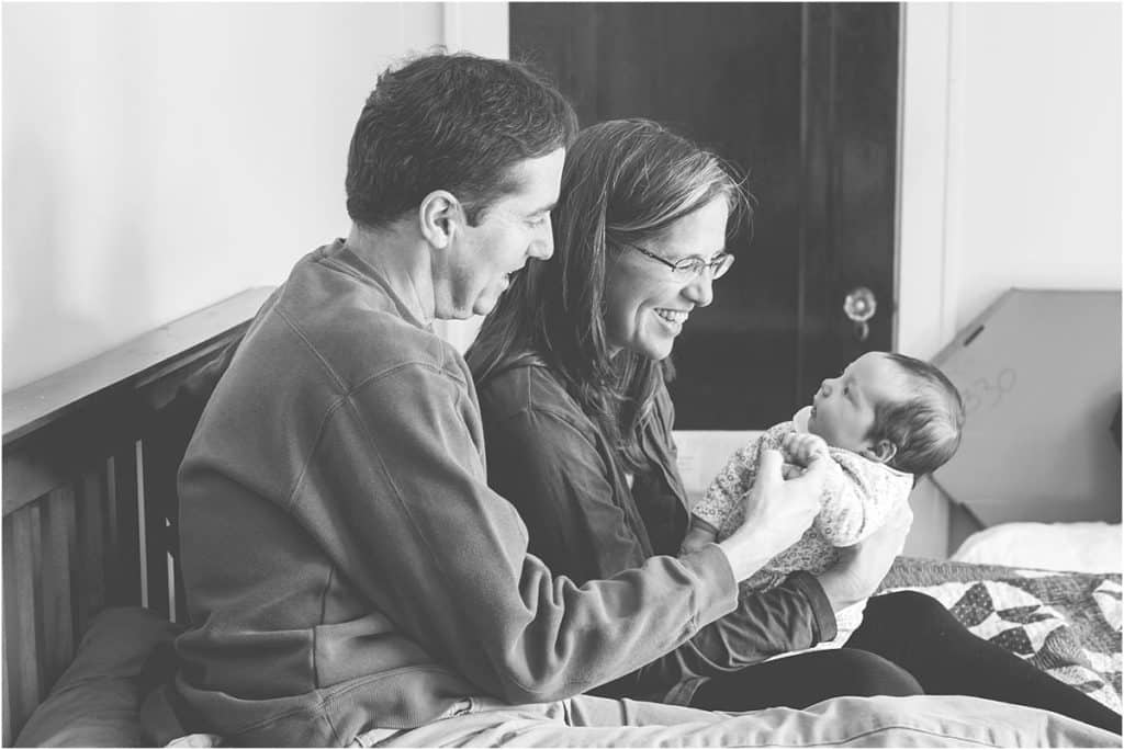 mary beth miller newborn session of mom dad and baby in bedroom