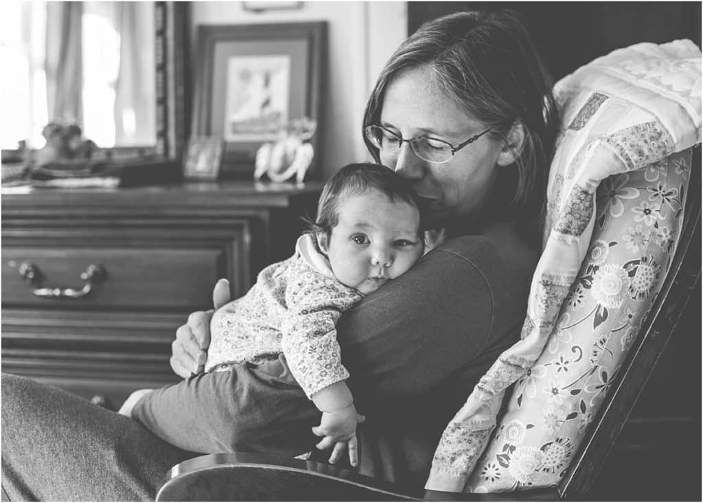 mom and newborn baby in rocking chair mary beth miller pittsburgh photographer black white