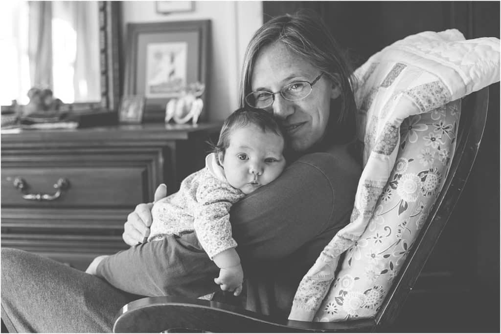 mom and newborn baby in rocking chair mary beth miller pittsburgh photographer black white