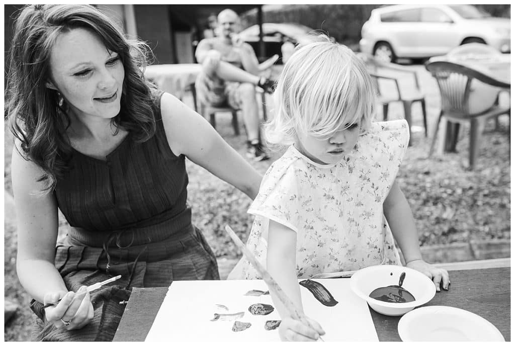 black and white photo of of mother and daughter doing art