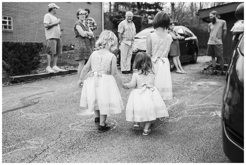 black and white photo of toddler girls holding hands