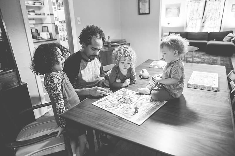 family playing game together at home for a pittsburgh lifestyle photo session