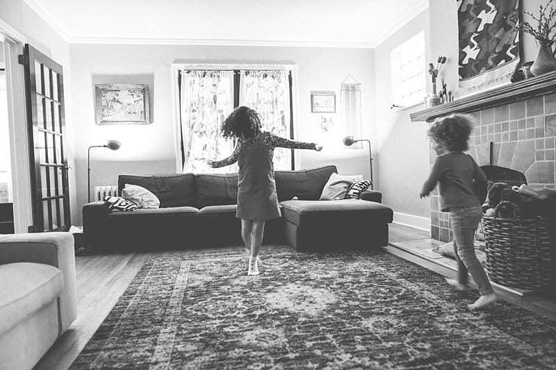 little girl dancing in living room for a photo session at his home in pittsburgh