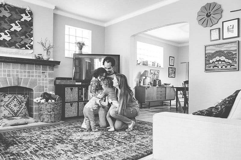 family dancing in living room for a photo session at his home in pittsburgh