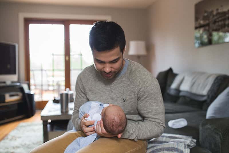 dad holding newborn baby at home in pittsburgh