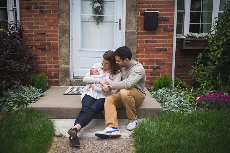 mom and dad with newborn baby outside their home in pittsburgh