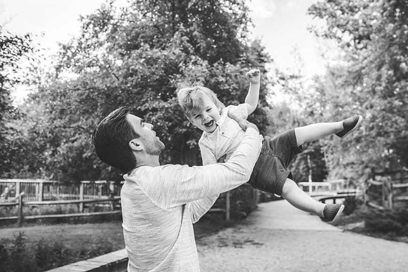 father tossing son at family photo session at beechwood farms pittsburgh 