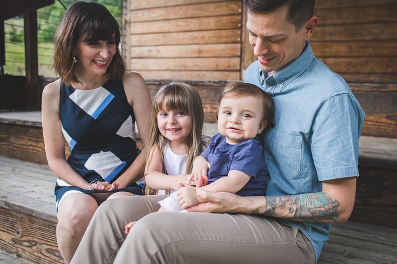 father with arm tattoo holding baby boy with pittsburgh family