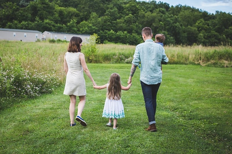 family holding hands for photo walking away