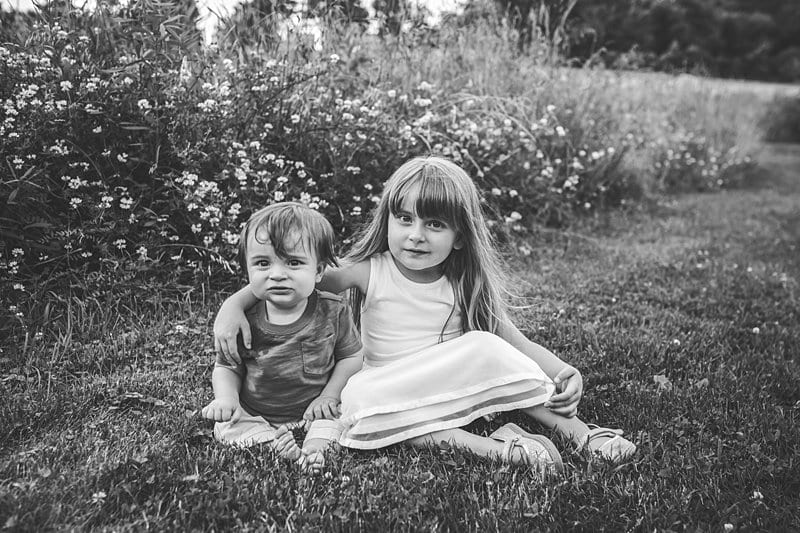 brother and sister children in field with wildflowers at sunset in pittsburgh 