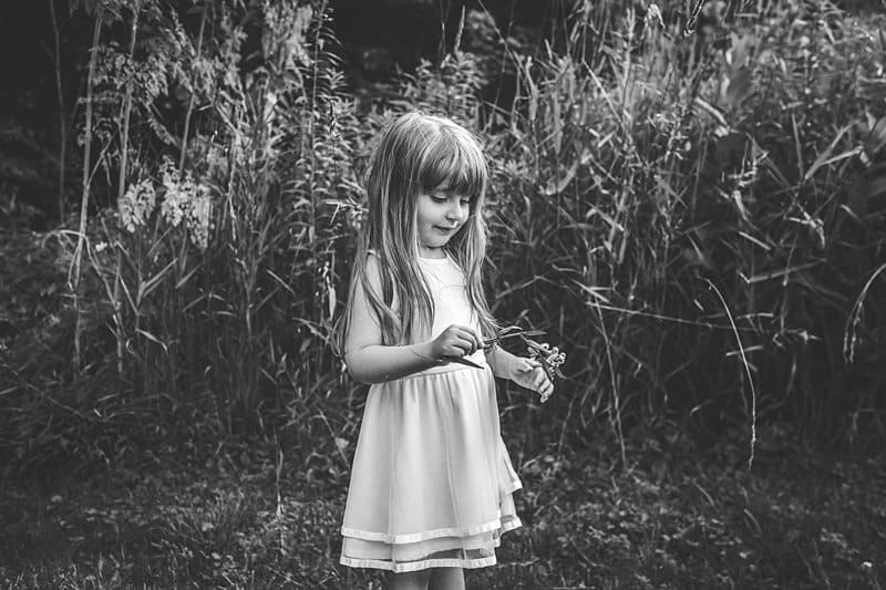 little girl with flower in pittsburgh field at boyce mayview park 