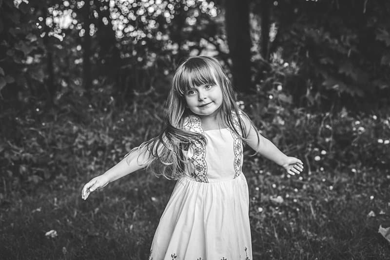 little girl dancing and twirling dress in black and white