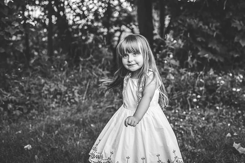 little girl dancing and twirling dress in black and white