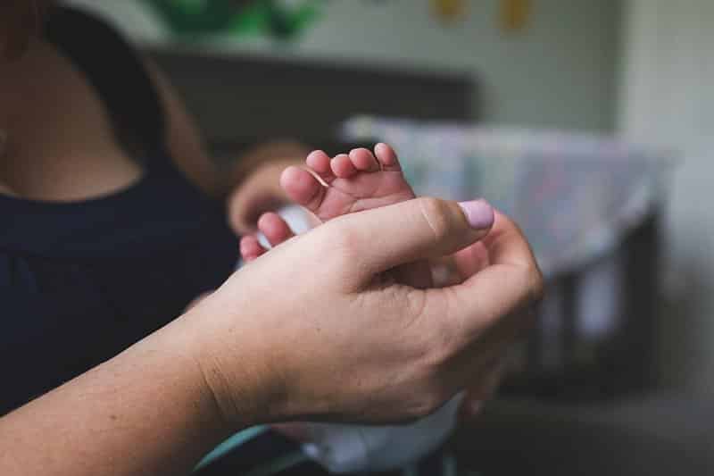 pittsburgh mom in nursery with newborn toes feet lifestyle photo session 