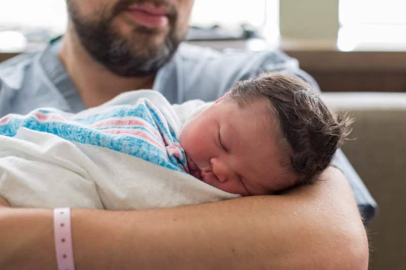 newborn with dad in hospital bed birth session in pittsburgh