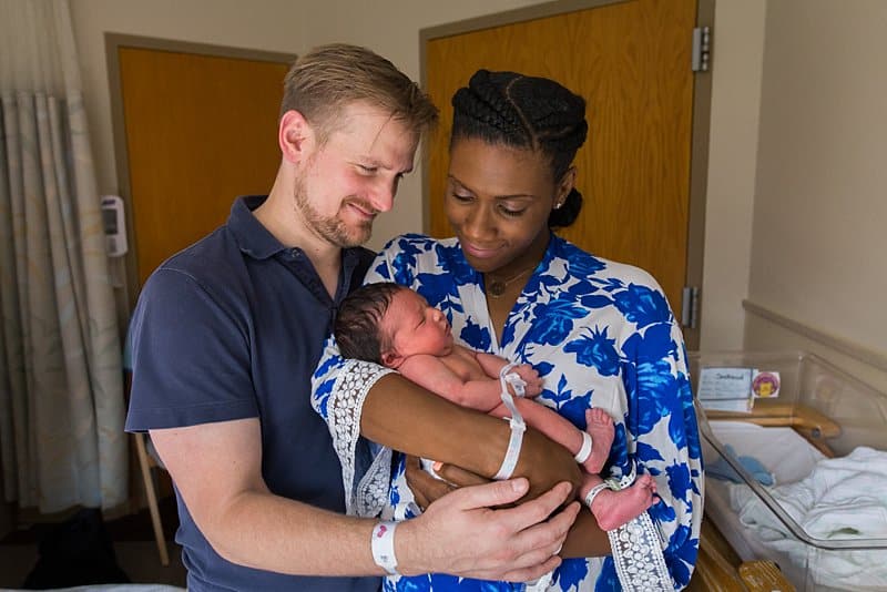mom and dad at magee hospital holding newborn baby