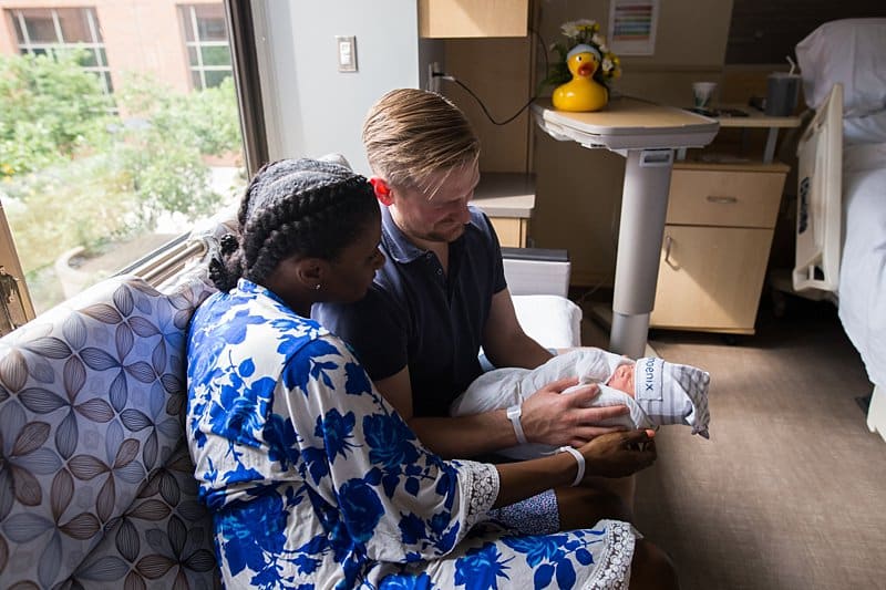 mom and dad at magee hospital holding newborn baby