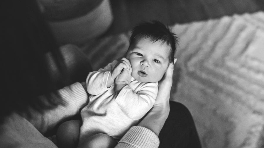 newborn held by mom in pine township nursery