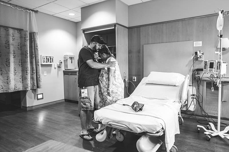 husband supports wife during labor in hospital