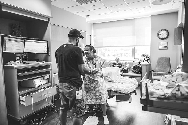 husband and doula supports woman during natural labor in magee hospital