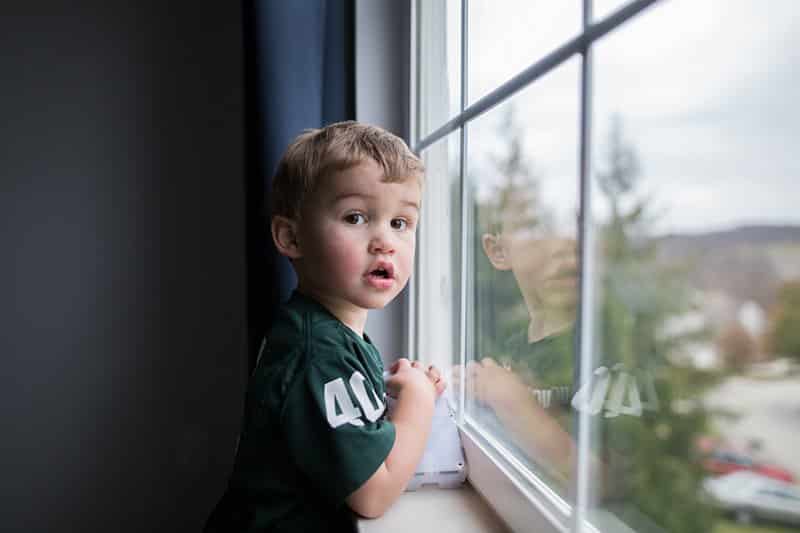 toddler looking out window