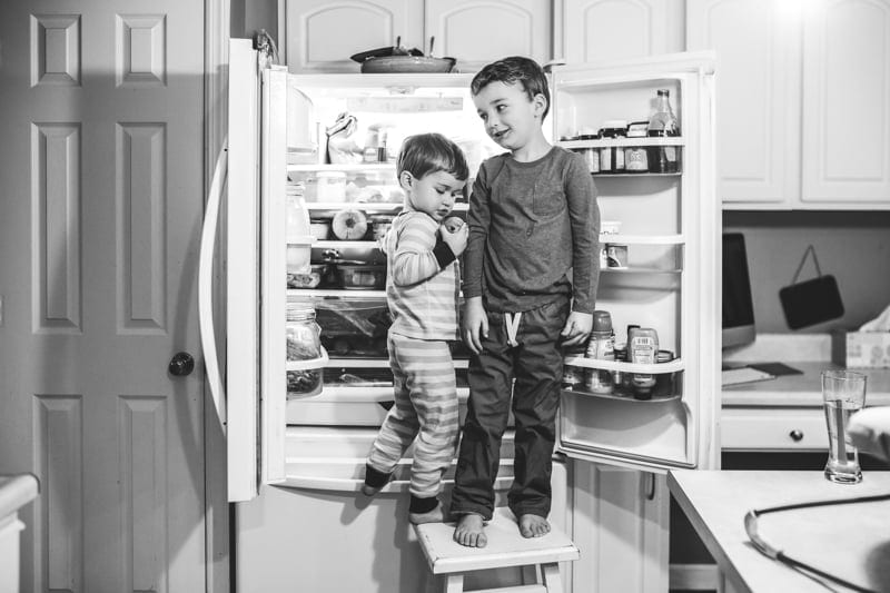 two brothers standing in fridge photo session
