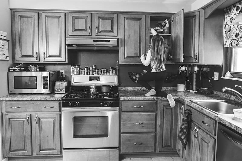 little girl on counter in kitchen