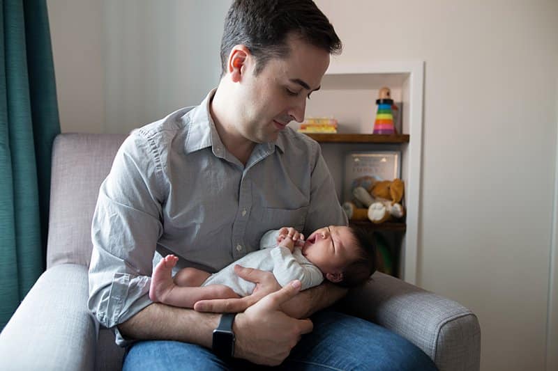 dad with newborn son in pittsburgh nursery for lifestyle session 
