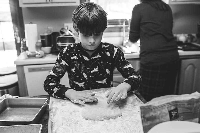 boy kneading dough mom doing dishes allison park kitchen