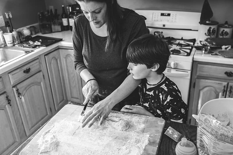 boy kneading dough mom doing dishes allison park kitchen