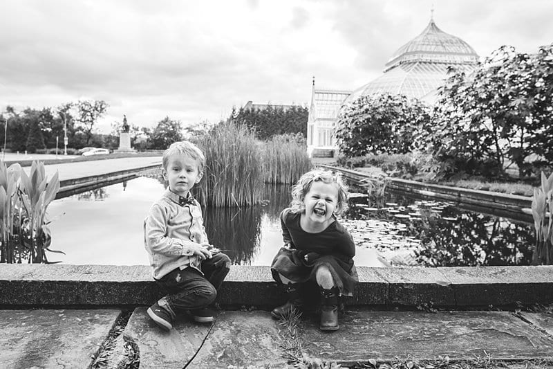 twin brother and sister sitting on fountain at phipps