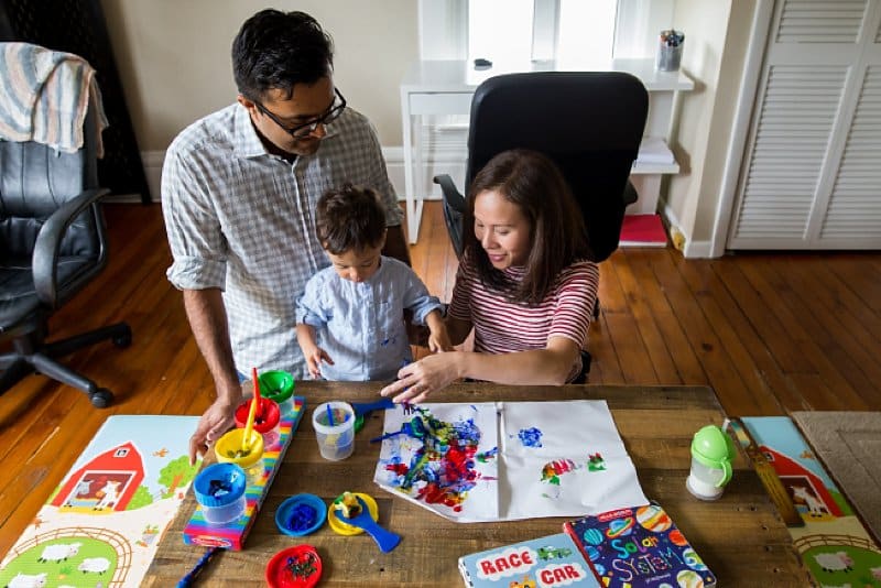 mother father and son painting together in pittsburgh home