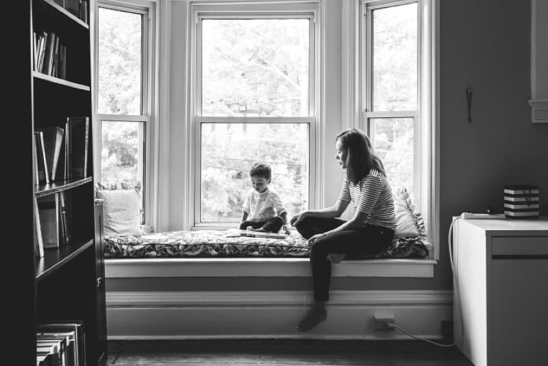 mother and son in window seat of shadyside home