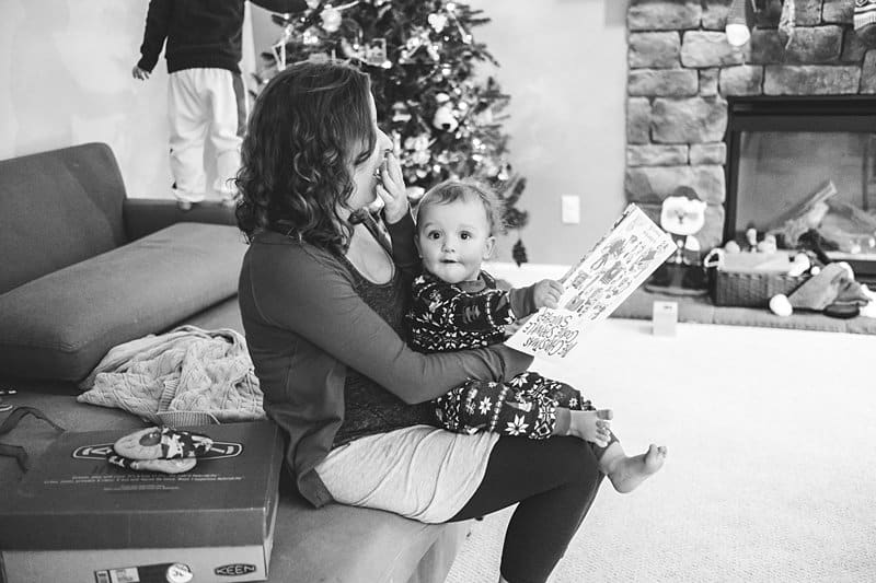 mom holding and reading to toddler