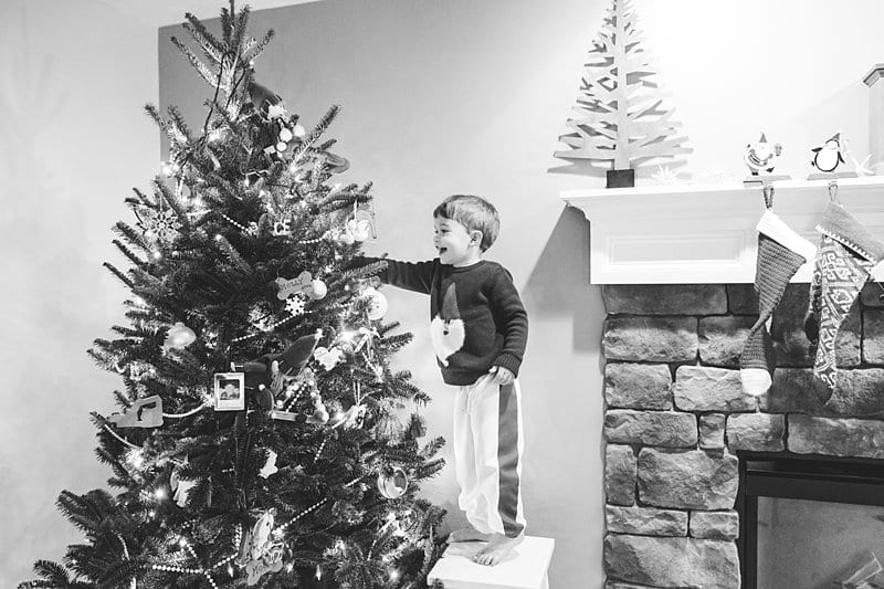boys decorating christmas tree
