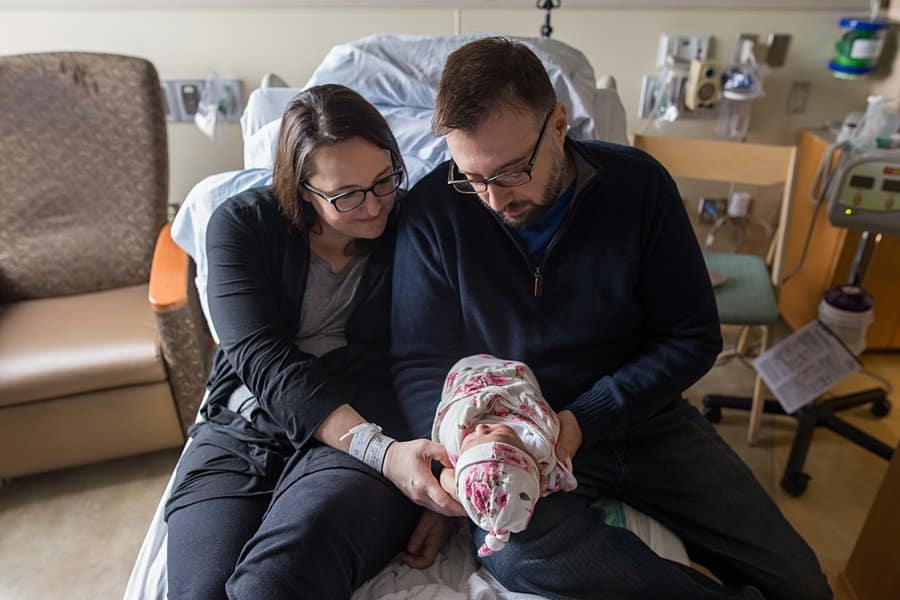 mom and dad with newborn baby on hospital bed in pittsburgh for a fresh 48 session