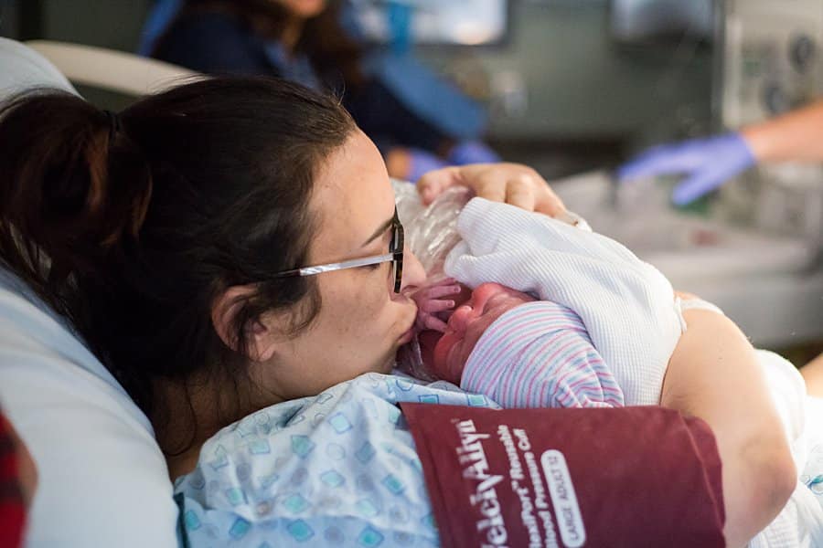 mom holding newborn at hospital 