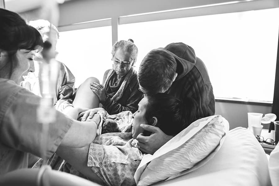father embraces mother in delivery room